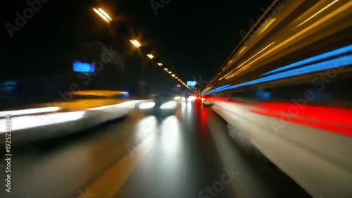 High speed motion blur view inside tunnel with colorful light trails creating dynamic sense of rapid movement