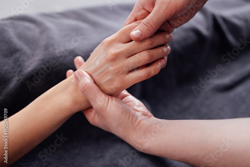 Wallpaper Mural Close-up of two hands engaged in a gentle massage, showcasing relaxation and care, with soft fabric background enhancing the soothing atmosphere of wellness therapy Torontodigital.ca