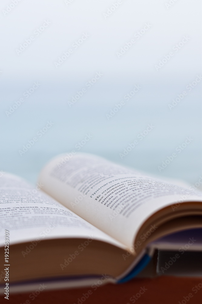 Fototapeta premium Open book with shallow depth of field and copy space for text
