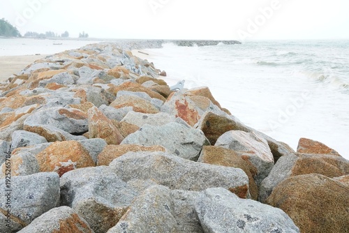 Bild auf Leinwand A large stone fort on the shore to prevent erosion from waves