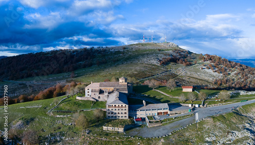 Aerial drone view of the autumn landscape surrounding the beech forest and the Sanctuary of San Miguel de Excelsis in the Sierra de Aralar. Huarte-Araquil, Navarre, Spain, Europe