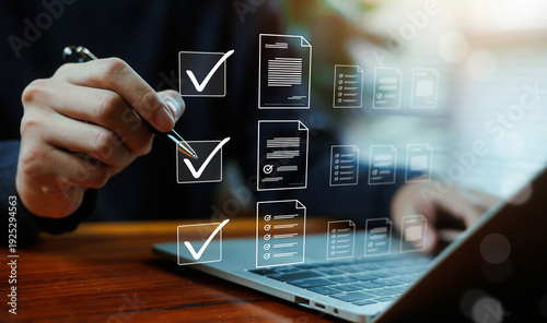 Foto Digital document management and compliance checklist concept with business professional approving files on laptop