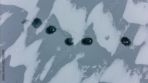
Fishing holes on a frozen lake from above