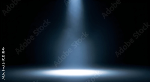 Dramatic blue spotlight illuminates dark stage background with vibrant light beam on empty floor. Ideal for presentations, product showcases, abstract concepts, or performance desi