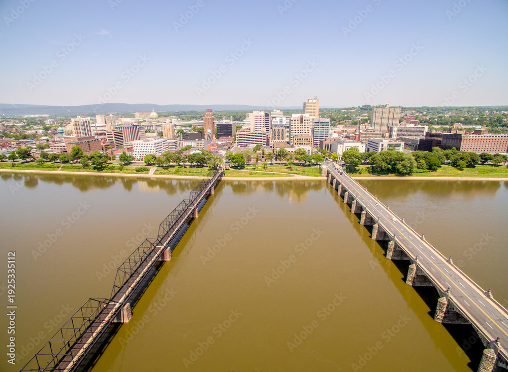 Fototapeta premium A city with a bridge over a river and a bridge over a canal