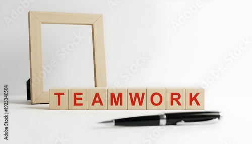 Teamwork concept with wooden blocks and pen on white background symbolizing collaboration and partnership