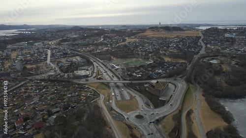 Wallpaper Mural Aerial drone footage showing vehicle traffic moving through a suburban area in Norway during late winter. The scene captures residential neighborhoods, roads, and surrounding landscape under cold seas Torontodigital.ca