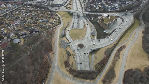 Wallpaper Mural Aerial drone footage showing vehicle traffic moving through a suburban area in Norway during late winter. The scene captures residential neighborhoods, roads, and surrounding landscape under cold seas Torontodigital.ca