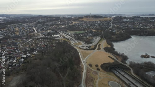 Wallpaper Mural Aerial drone footage showing vehicle traffic moving through a suburban area in Norway during late winter. The scene captures residential neighborhoods, roads, and surrounding landscape under cold seas Torontodigital.ca