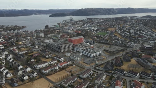 Wallpaper Mural Aerial drone footage showing vehicle traffic moving through a suburban area in Norway during late winter. The scene captures residential neighborhoods, roads, and surrounding landscape under cold seas Torontodigital.ca