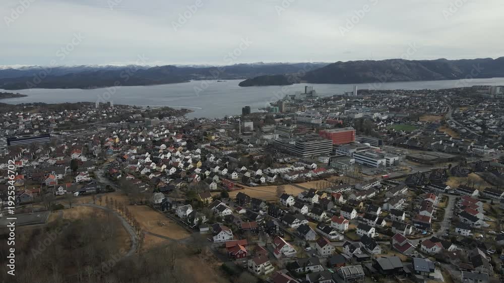 custom made wallpaper toronto digitalAerial drone footage showing vehicle traffic moving through a suburban area in Norway during late winter. The scene captures residential neighborhoods, roads, and surrounding landscape under cold seas