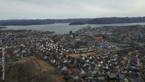 Wallpaper Mural Aerial drone footage showing vehicle traffic moving through a suburban area in Norway during late winter. The scene captures residential neighborhoods, roads, and surrounding landscape under cold seas Torontodigital.ca