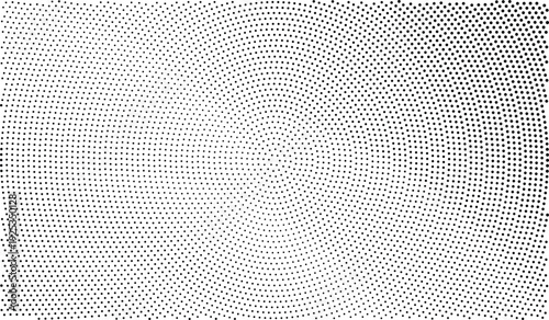 A black and white photo of a circular pattern made from small dots arranged in a spiral design on a flat surface