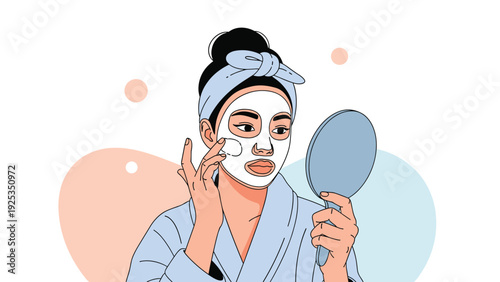 Young woman in a bathrobe applying a white clay face mask while looking in a hand mirror as part of her daily beauty routine.