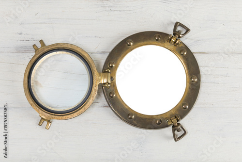 Vintage porthole with transparency in white wooden wall