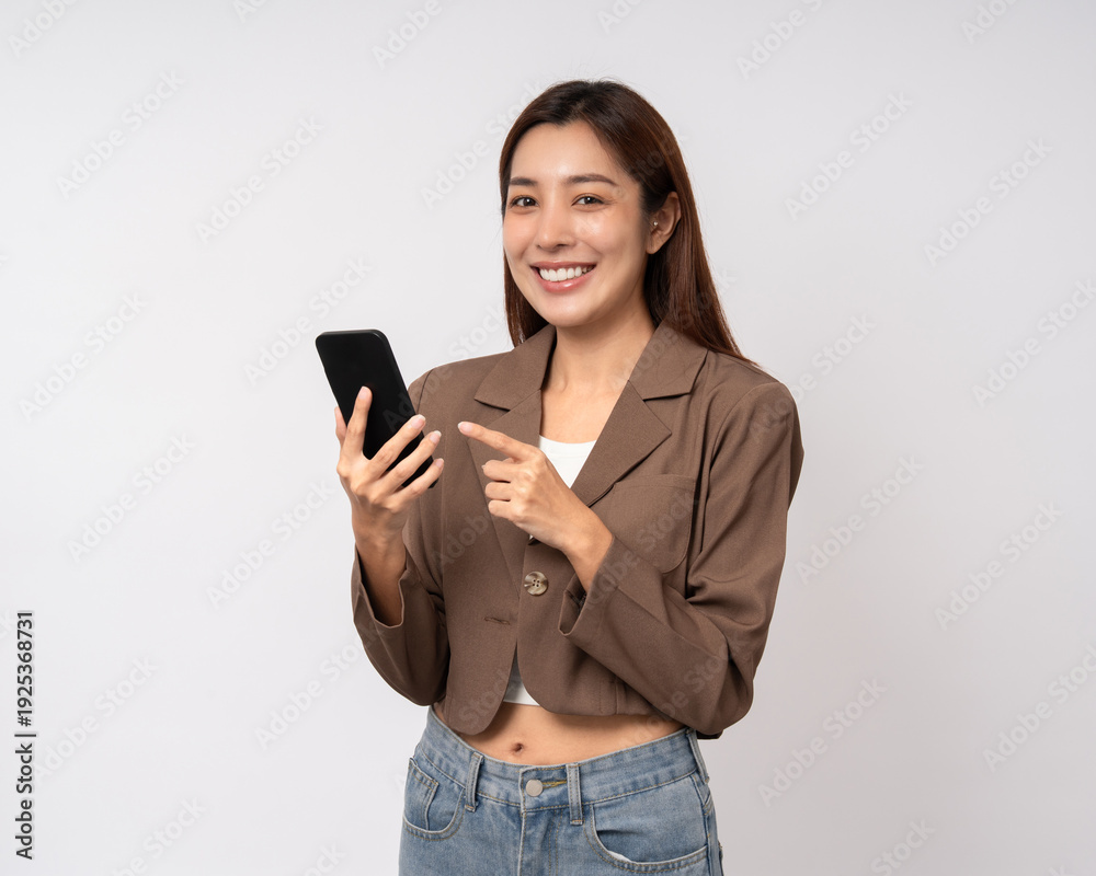 Naklejka premium Pretty young asian woman using cellphone standing on isolated white background. Happy Excited Beautiful young asian shopping online payment with mobile phone. Playing game on smartphone