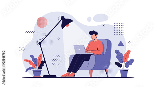 Student or professional sits in a comfortable blue armchair working on a laptop late at night under the light of a floor lamp.
