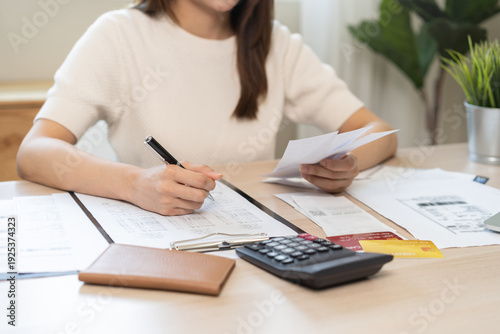 Vászonkép Deduction planning, debt asian young woman calculating money balance of finance from bill and income, cost budget expenses for pay money form personal individual on table at home