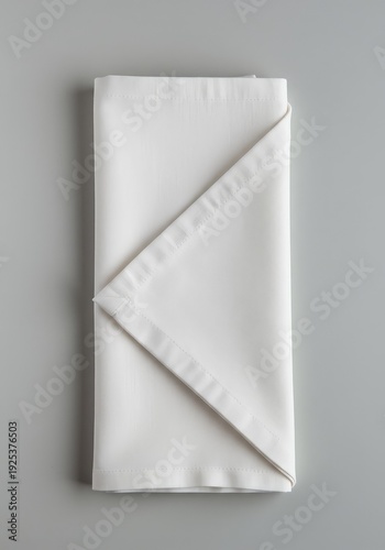 Crisp white cotton napkin, neatly folded for a formal place setting. Essential soft textile used for elegant dining and decorative purposes ,fabric ,preparation ,white