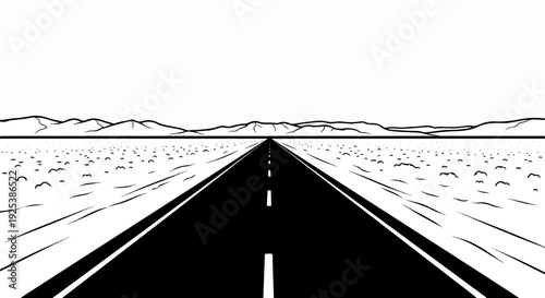 Endless asphalt road stretching towards distant mountains across a barren desert