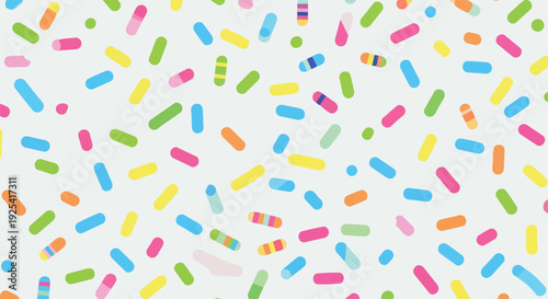 Playful confetti-like sweet candy toppings scattered on a light grey surface.