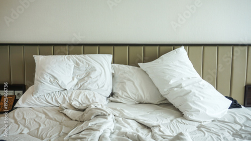 Obraz na płótnie Crumpled bed sheet, a blanket and pillows after comfort duvet sleep waking up in the morning