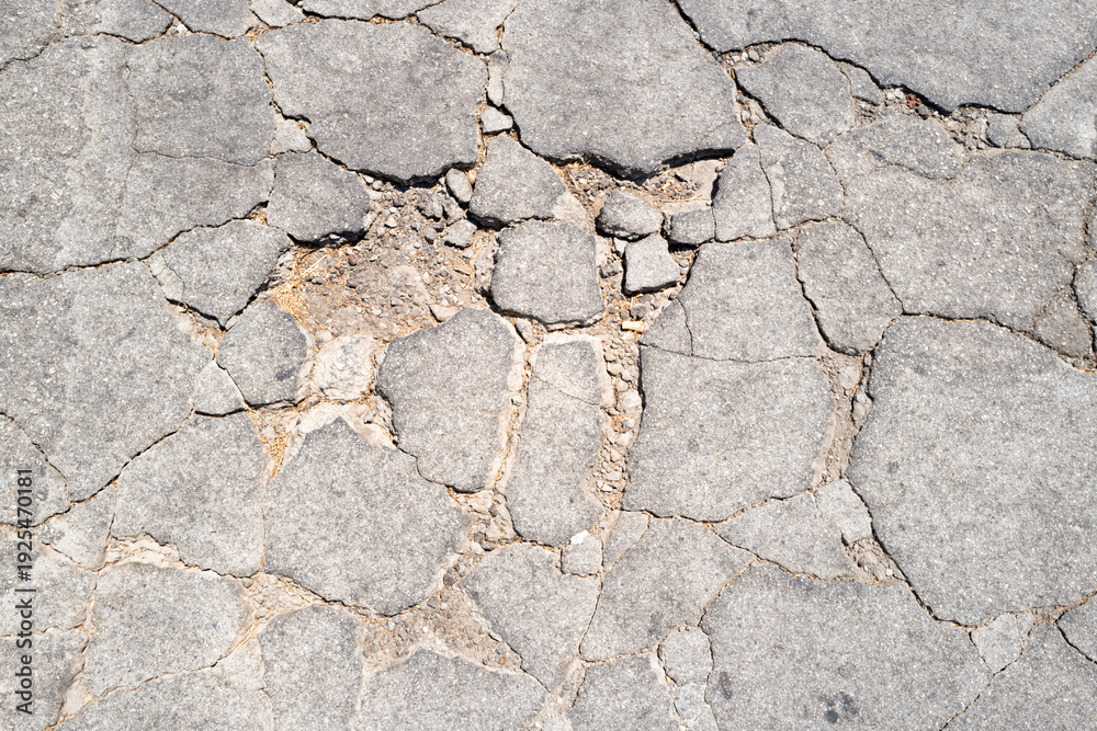 Obraz premium Texture cracked asphalt surface. Texture damaged road background. Texture rough concrete detail. Texture urban pavement pattern.