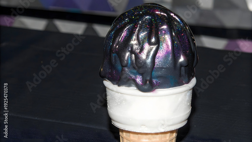 A macro shot of futuristic black ice cream with a glossy, mysterious texture. Dark, elegant, and otherworldly dessert concept with smooth curves and modern aesthetic.