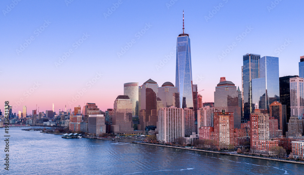 Obraz premium New York City skyline with skyscrapers at sunset. NYC night skyline with Manhattan. New York panoramic cityscape. New York City aerial view of Manhattan. New York skyline with Tower at sunset.