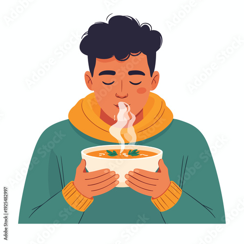 A young man enjoying a steaming bowl of soup on a chilly day indoors with a relaxed expression and closed eyes