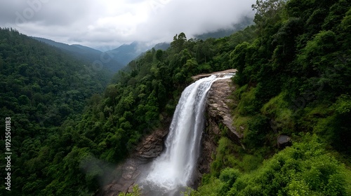 Majestic waterfall cascades through a lush green jungle under a cloudy sky