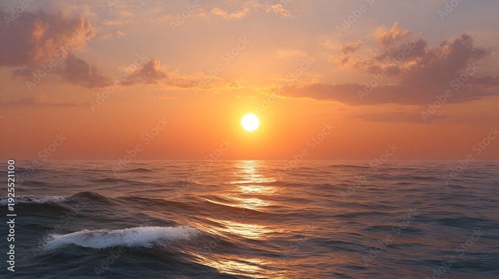 Obraz premium A spectacular sunset paints the ocean horizon with vibrant orange and pink hues reflecting golden light on gentle waves under a cloudy sky