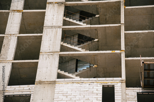 Concrete building structure with exposed staircases under construction