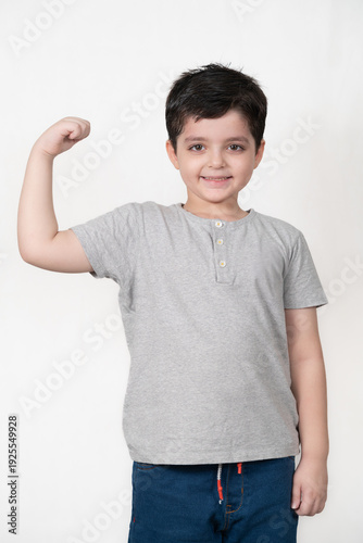 Confident Little Boy Flexing His Bicep with a Happy Smile