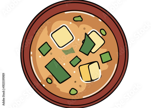 A bowl of miso soup with tofu and seaweed.