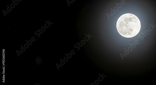 A bright moon shining in the dark night sky with soft glow