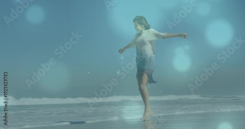 Wallpaper Mural Woman walking shore stepping toward lens sparking animated bokeh reflecting on wet sand for travel Torontodigital.ca