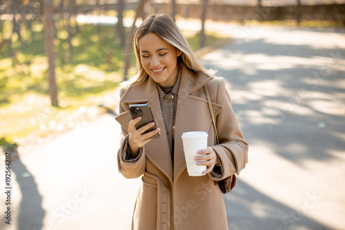 Woman looks at her phone wh...