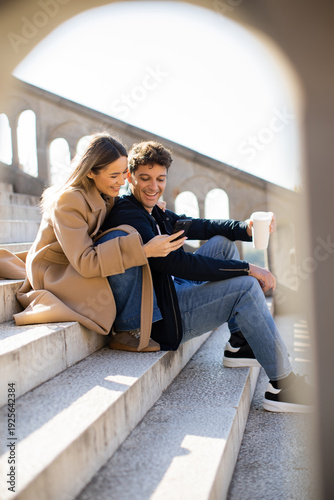 Couple sitting on steps loo...