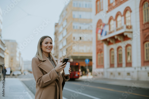 Woman stands on city street...