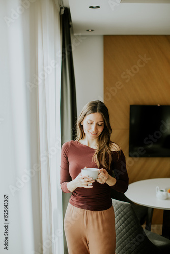 Woman enjoys a warm drink w...