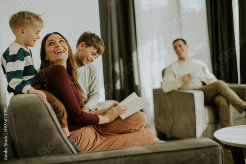 Photos Family enjoys reading time together in a cozy living room