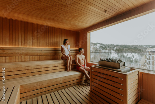 Couple relaxing in sauna wi...