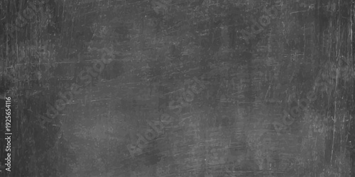 A dark grunge metal background featuring a textured black and white pattern on an old rough concrete wall surface with aged vintage paper and grey fabric linen canvas backdrop