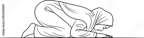 Muslim woman in prostrate position during prayer