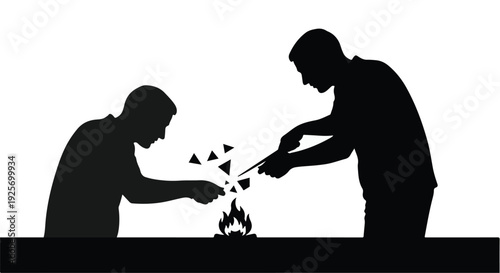 silhouette of two men burning papers over flame