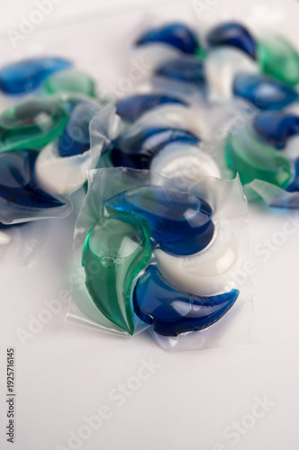 Close-up of a laundry pod with blue and green liquid detergent