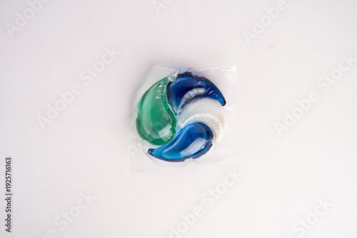 Close-up of a laundry pod with blue and green liquid detergent