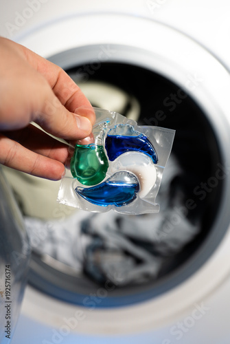 Close-up of a laundry pod with blue and green liquid detergent
