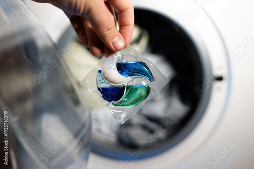 Close-up of a laundry pod with blue and green liquid detergent
